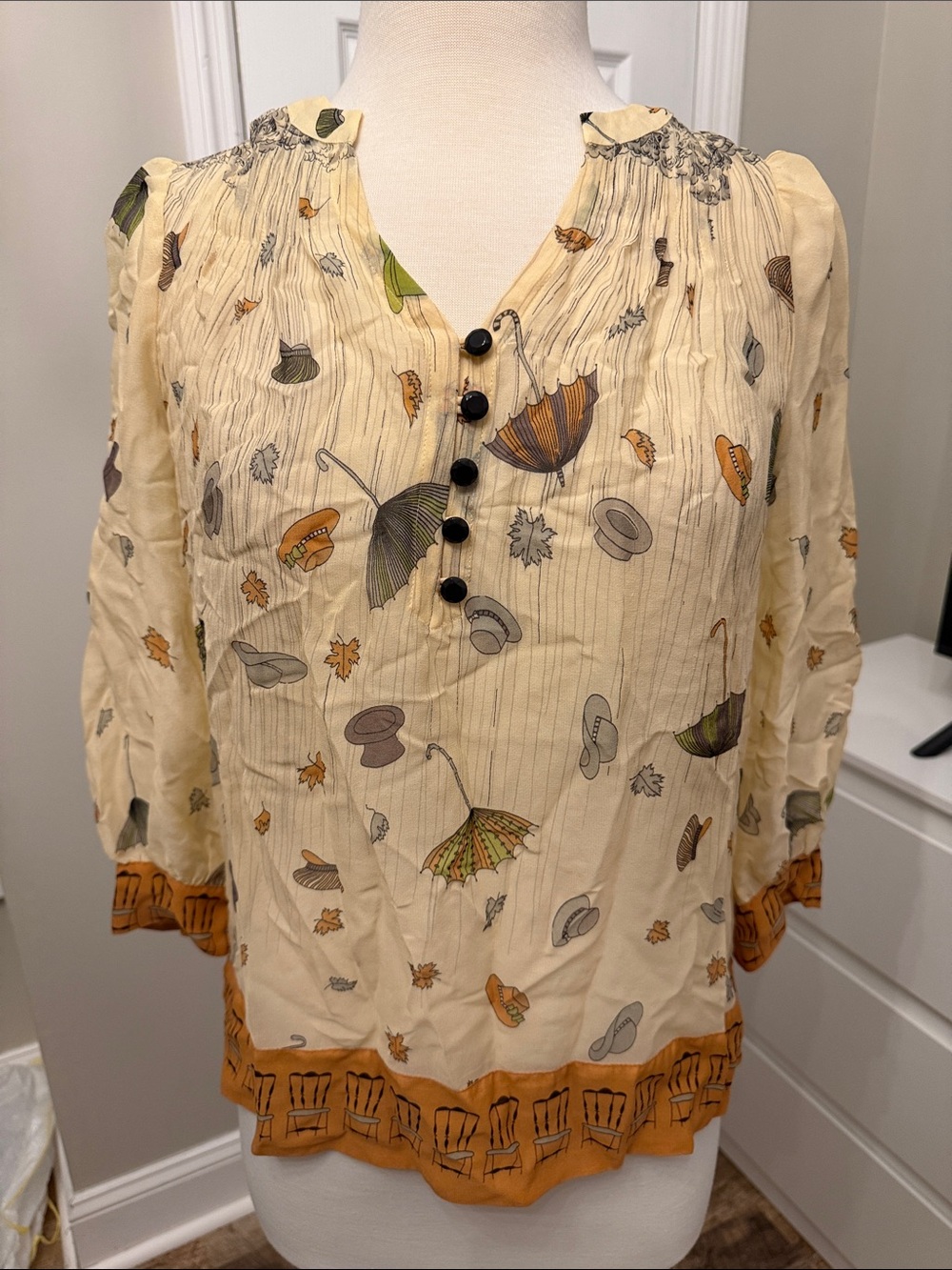 Floreat Cream Printed V-Neck Blouse with Black Buttons and Rust Trim